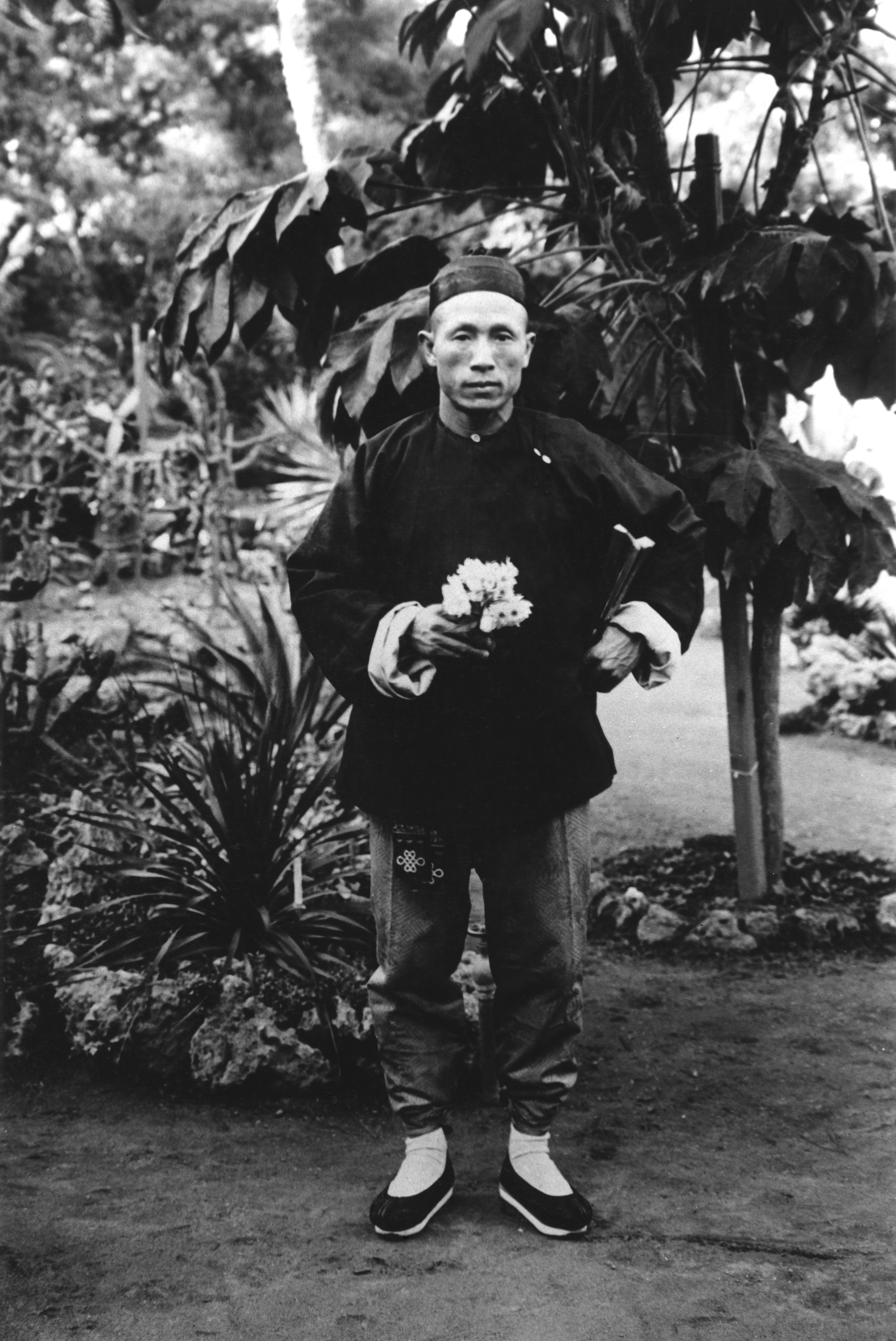 Nea Lee, head gardener at the Del Monte Hotel in Monterey, holding narcissus in the 1880s
