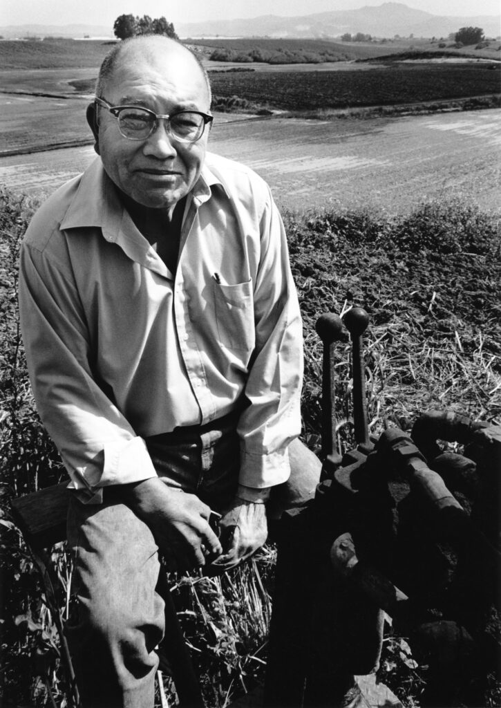 Sam Chinn on his carrot machine in Salinas, 1983